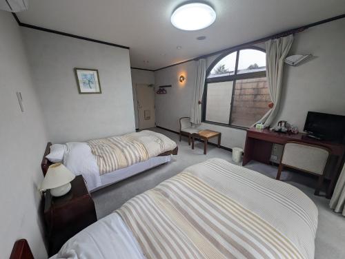Una cama o camas en una habitación de プチホテル　MASUYA