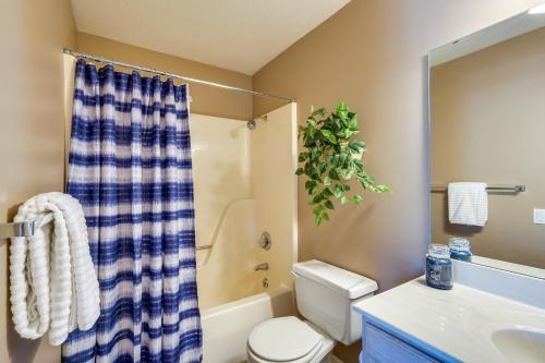 a bathroom with a toilet and a shower and a sink at Waterfront Lazy Days Condo with Views and Pool Access! in Osage Beach