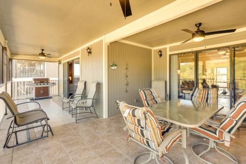 a dining room with a table and chairs at Waterfront Lazy Days Condo with Views and Pool Access! in Osage Beach
