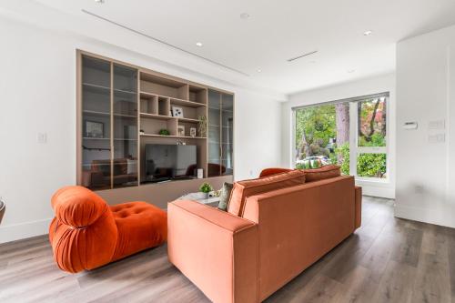a living room with a couch and a chair at Charming and Modern Retreat in Vancouver Trendy 42nd Avenue Neighbourhood in Vancouver