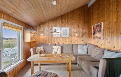 a living room with a couch and a table at Pet Friendly Home In Thisted With Sauna in Thisted