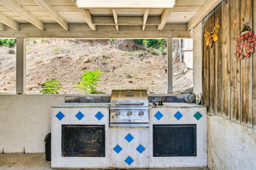 an outdoor kitchen with a stove in a backyard at San Diego Home AC, Hot Tub, Covered Patio and BBQ in Spring Valley