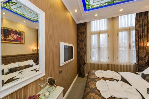 a bedroom with a large mirror and a bed at Alpek Hotel in Istanbul