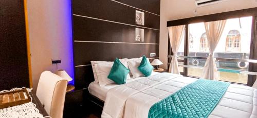 a bedroom with a large bed and a window at Victoria Houseboats in Alleppey