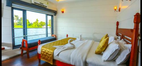 a bedroom with a bed with swans on it at Victoria Houseboats in Alleppey