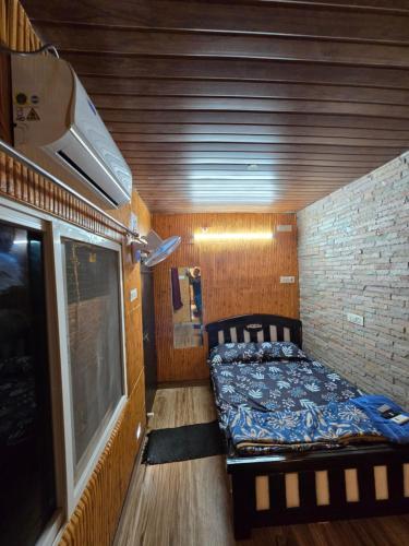 a small room with a bed and a window at Barla's Home Stay in Shamshabad
