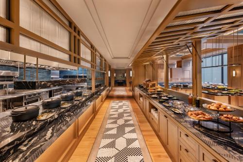 a restaurant with a buffet line with food at JW Marriott Auckland in Auckland