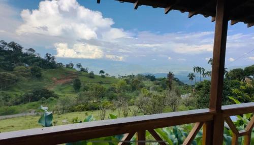 a view from a balcony of a field and trees at My Paradise Tamesis in Támesis