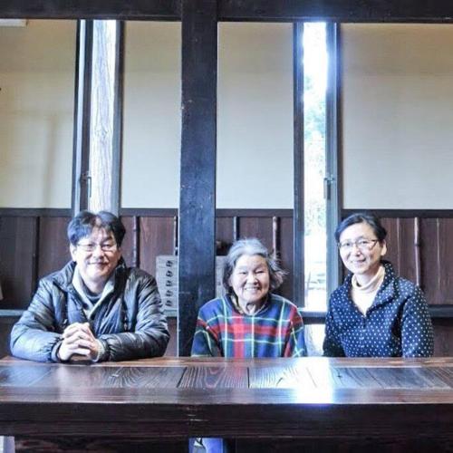 three older women sitting at a wooden table at 一棟貸切 古民家民泊あさひ in Sado