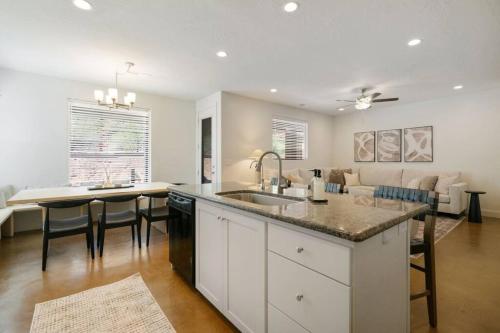 a kitchen and living room with a sink and a table at Retreat, Zion view, Hot Tub, RV Parking, 27 miles Zion in Apple Valley