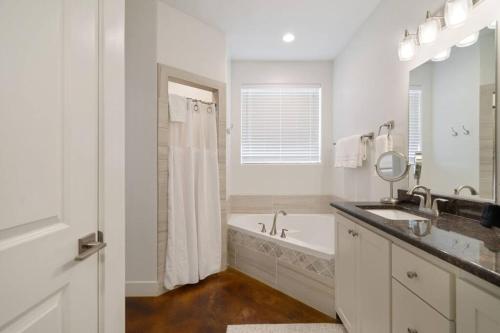 a white bathroom with a tub and a sink at Retreat, Zion view, Hot Tub, RV Parking, 27 miles Zion in Apple Valley