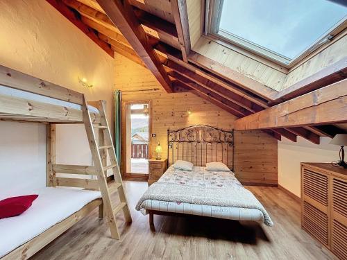 a bedroom with two bunk beds and a ladder at Chalet Savage 170m² près des pistes, Wi-Fi, parking, matériel bébé - FR-1-267-299 in Villarembert