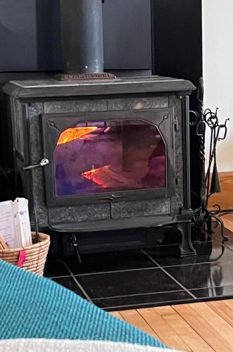 a stove that is sitting in a room at Retro-chic retreat in the heart of Wakefield in Wakefield