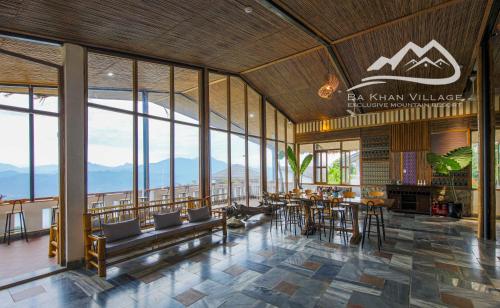 a dining room with a view of the mountains at Bakhan Village Resort in Mai Chau