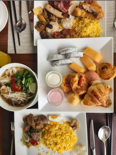 a collage of different plates of food on a table at Da Nang Beachfront Apartment Balcony, Infinity Pool By A La Carte in Da Nang