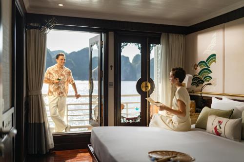 a man and a woman in a hotel room at The Au Co Cruise - Managed by Bhaya Cruise in Ha Long
