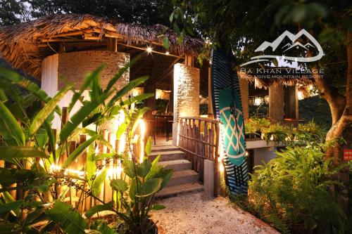 a resort with stairs leading to a building with lights at Bakhan Village Resort in Mai Chau