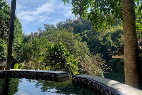 a view of a pool of water with trees in the background at The Cascade - Mae Taeng Waterfall Bungalows in Ban Mae Ta Man (1)