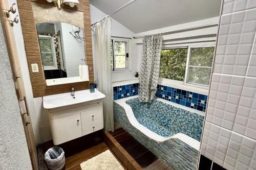 a bathroom with a tub and a toilet and a sink at The Cascade - Mae Taeng Waterfall Bungalows in Ban Mae Ta Man (1)