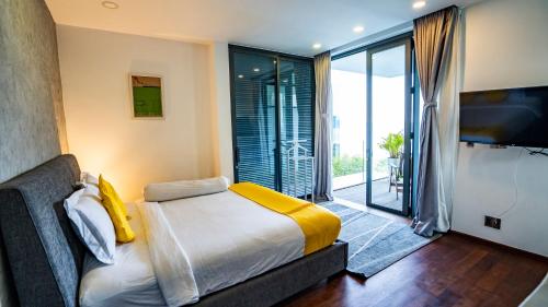 a bedroom with a bed and a large window at Anh Nguyen Oceanfront Luxury Villas Nha Trang in Nha Trang