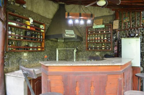 a bar in a room with bottles of wine at Hostal Casa San Mateo in León
