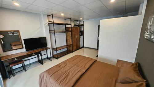 a bedroom with a large bed and a television at Smile Home โรงแรม ห้องพัก รายวัน รายเดือน in Ban Zong Katiam