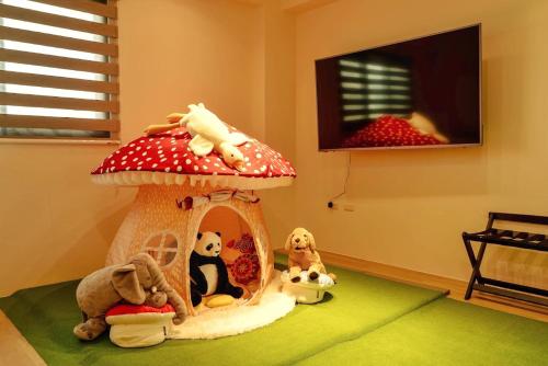 a room with stuffed animals in a mushroom house at 家太幸福民宿 in Xingjian