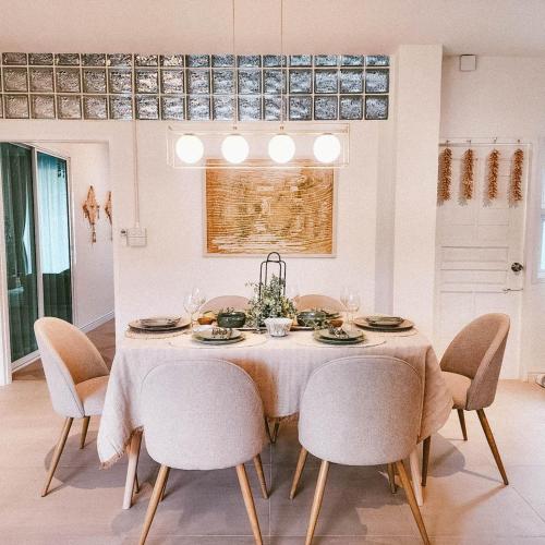 a dining room with a table and chairs at Le lanna villa at Center of old town with private pool in Chiang Mai