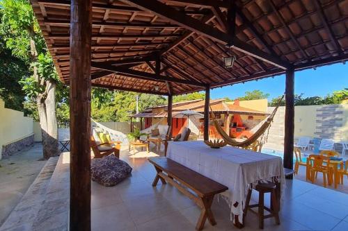 a wooden pavilion with a table and chairs on a patio at Espaço Bem Bom in Andaraí