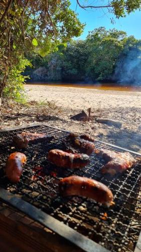 a grill with meat cooking on top of it at Espaço Bem Bom in Andaraí