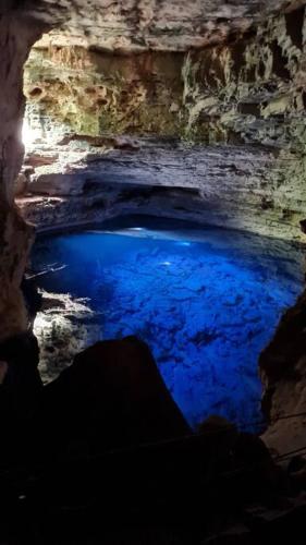 a blue pool of water in a cave at Espaço Bem Bom in Andaraí