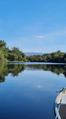 a boat on a lake with trees in the background at Espaço Bem Bom in Andaraí