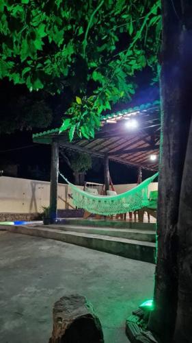 a park at night with a tree and a hammock at Espaço Bem Bom in Andaraí