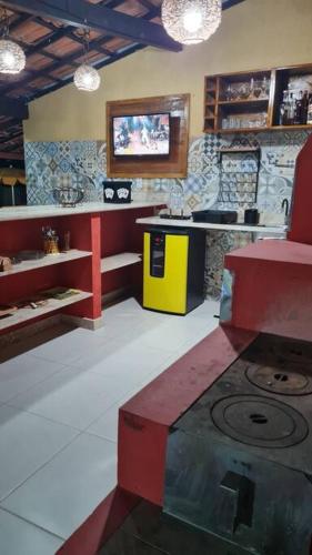 a kitchen with a stove in the middle of a room at Espaço Bem Bom in Andaraí