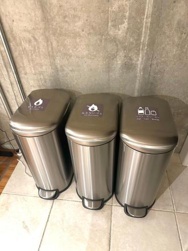 two trash cans sitting next to each other at 茅ヶ崎サザンビーチリゾート in Chigasaki