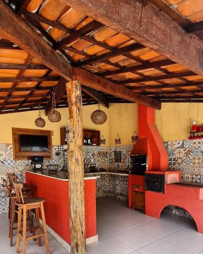 a kitchen with a red counter and a stove at Espaço Bem Bom in Andaraí