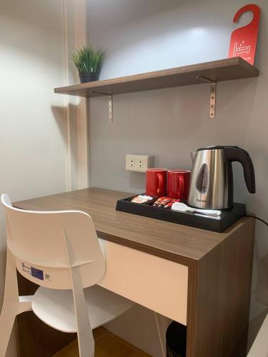 a desk with a tea kettle on top of it at Balay Talisay in Balogo