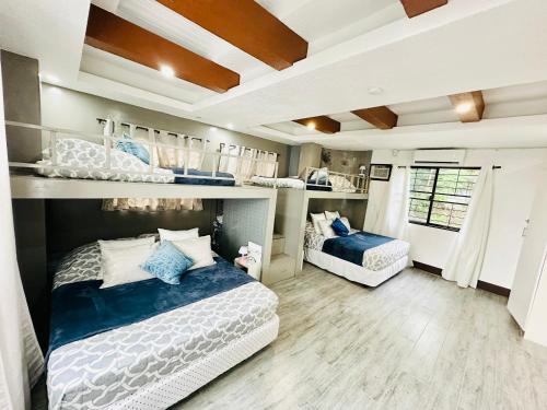 a bedroom with two beds in a room at Ocean View Villa in Bohol in Lila