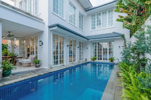 an exterior view of a house with a swimming pool at Viki Nest by SooBali 4BR in Umalas