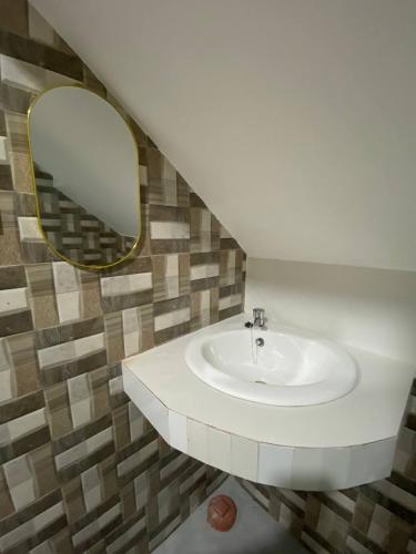 a bathroom with a sink and a mirror at RHM homestay in Naga