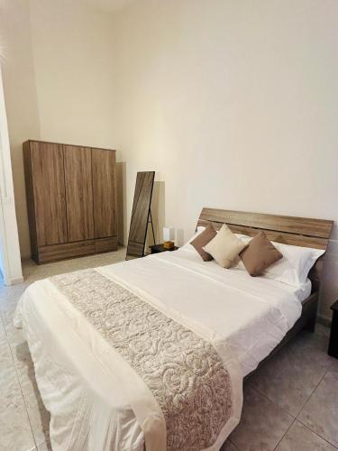 a bedroom with a large bed with white sheets and pillows at Horizon Haven, Mauritius in Flic-en-Flac