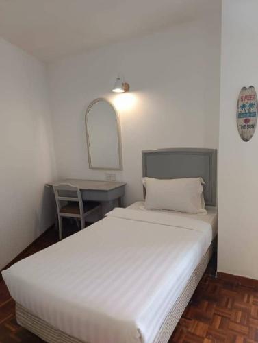 a white bed in a room with a table at Star Regency by Plush in Brinchang