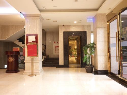 a lobby of a building with a sign in the middle at Chong Yu Hotel in Taoyuan