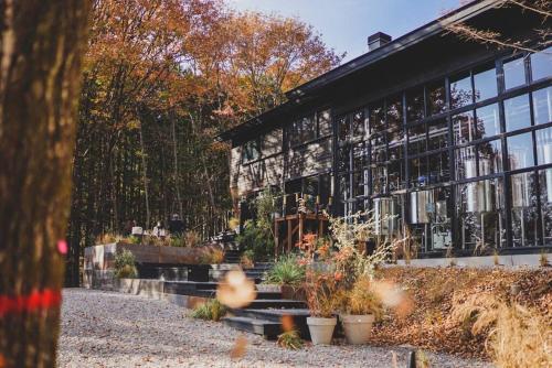 a building with a bunch of plants in front of it at vacation house huit 8 in Koshu