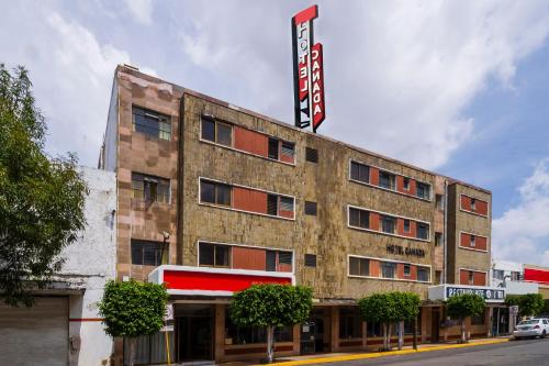a building with a sign on top of it at Hotel Canada, Guadalajara in Guadalajara