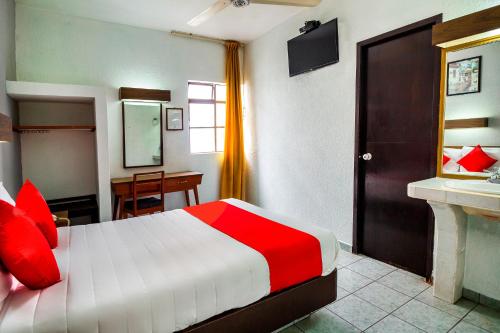 a bedroom with a red and white bed and a desk at Hotel Canada, Guadalajara in Guadalajara