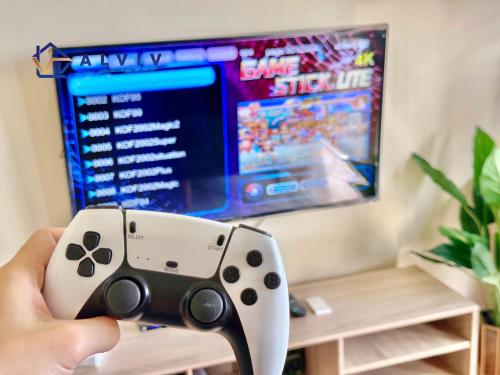 a person holding a video game controller in front of a tv at Costa Mahkota - 1min I Mahkota Parade Mall I Dataran Pahlawan I Mahkota Hospital in Melaka