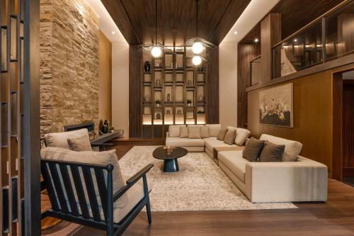 a living room with a couch and a table at Plataran Puncak Residences in Puncak