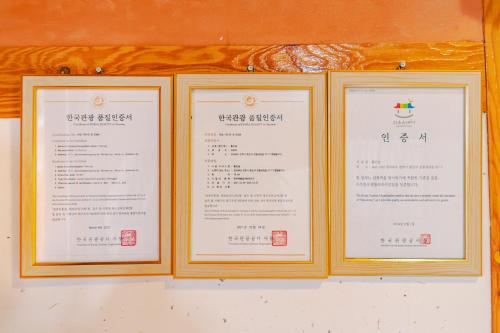 three framed menus sitting on a wall at Beautiful Garden Fine Day House in Jeonju