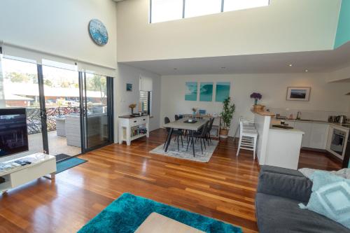 a living room with a couch and a table at Margaret River Retreat on Fearn in Margaret River Town